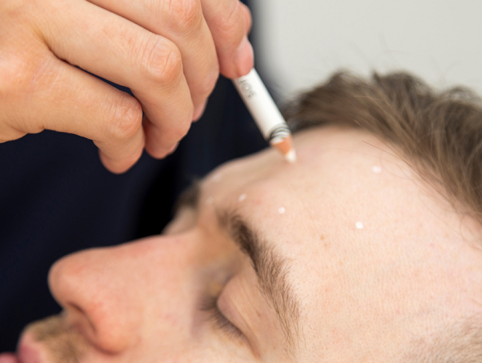 Man preparing for a facial skincare treatment